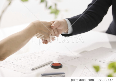 Hands of two women who conclude a real estate contract 97929732