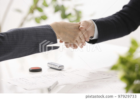 Hands of two women who conclude a real estate contract 97929733