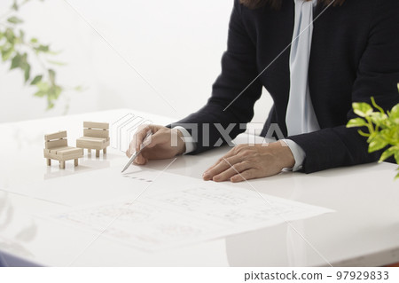 Hands of two women who conclude a real estate contract Hands of two women who conclude a real estate contract 97929833