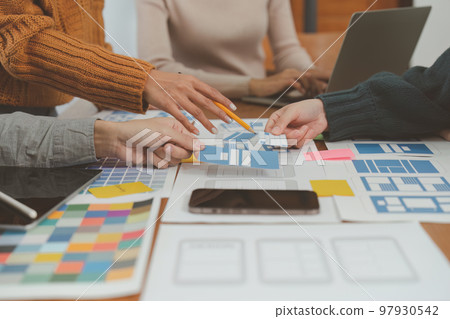 Young Asian Start up new business working at creative office. Modern start-up business team. Co-workers ui, ux startup small business Young Asian Start up new business working at creative office. Modern start-up business team. Co-workers ui, ux startup small business 97930542