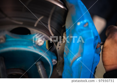 Checking car brake system for repair at car garage 97930731