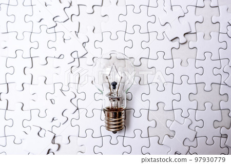 Sparking ideas Background textures of scattered jigsaw puzzles and light bulbs Strategies Standard colors 97930779