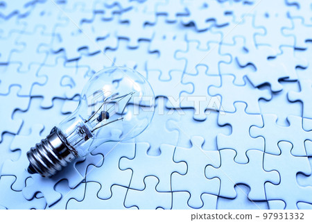 Sparking ideas Background textures of scattered jigsaw puzzles and light bulbs Strategies Cold colors 97931332