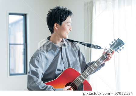 young man playing acoustic guitar young man playing acoustic guitar 97932154