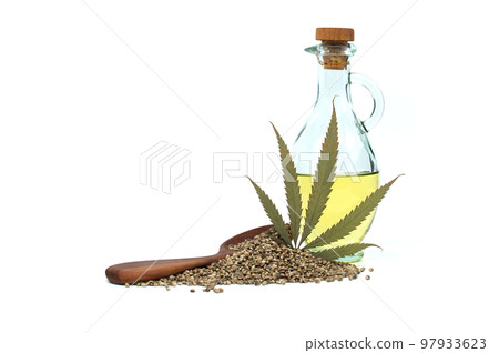 Hemp leaf, cannabis oil and hemp seeds over white 97933623