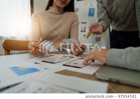 Young Asian Start up new business working at creative office. Modern start-up business team. Co-workers ui, ux startup small business 97934581