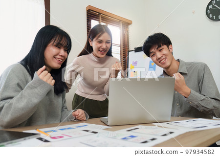 Young Asian Start up new business working at creative office. Modern start-up business team. Co-workers ui, ux startup small business Young Asian Start up new business working at creative office. Modern start-up business team. Co-workers ui, ux startup small business 97934582