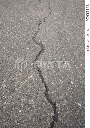 Cracks in the asphalt road 97935118