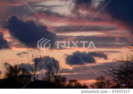 Dramatic sunset with dark clouds and glimpses of light. Dramatic sunset with dark clouds and glimpses of light. 97935317