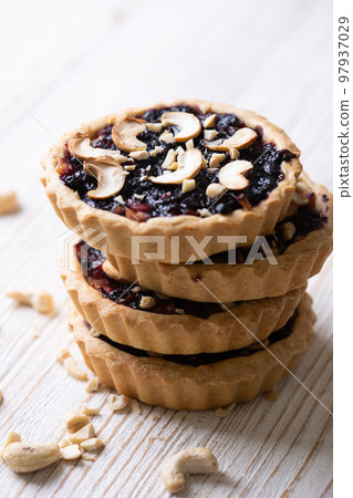 tartlets with apple jam and blueberry confiture tartlets with apple jam and blueberry confiture 97937029