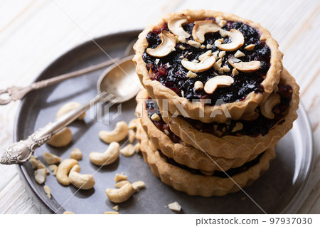tartlets with apple jam and blueberry confiture tartlets with apple jam and blueberry confiture 97937030
