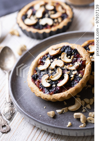 tartlets with apple jam and blueberry confiture tartlets with apple jam and blueberry confiture 97937139