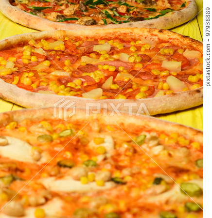 Hawaii pizza with meat, corn, tomatoes and cheese on yellow Hawaii pizza with meat, corn, tomatoes and cheese on yellow 97938889