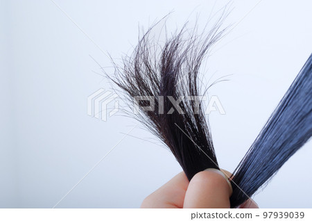A woman touching her hair 97939039