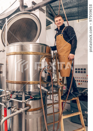 Man is working at craft beer factory. Man is working at craft beer factory. 97939658