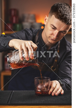 Bartender making negroni cocktail Bartender making negroni cocktail 97939660