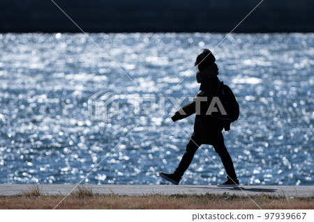 silhouette of people walking on the beach silhouette of people walking on the beach 97939667