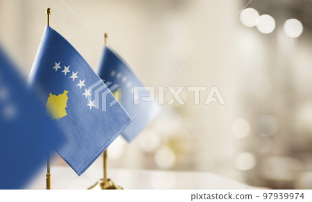 Small flags of the Kosovo on an abstract blurry background 97939974