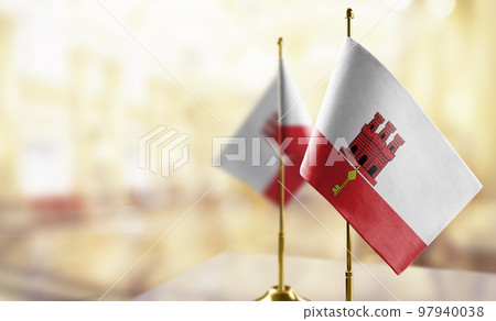 Small flags of the Gibraltar on an abstract blurry background Small flags of the Gibraltar on an abstract blurry background 97940038