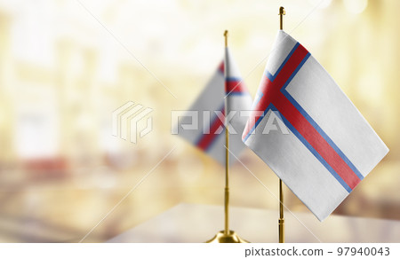 Small flags of the Faroe Islands on an abstract blurry background Small flags of the Faroe Islands on an abstract blurry background 97940043