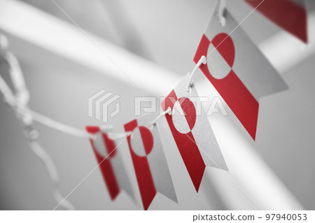 A garland of Greenland national flags on an abstract blurred background A garland of Greenland national flags on an abstract blurred background 97940053