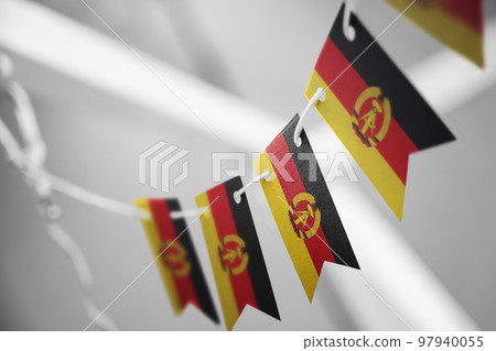 A garland of GDR national flags on an abstract blurred background 97940055