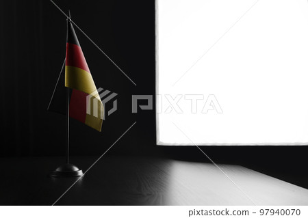 Small national flag of the GDR on a black background 97940070
