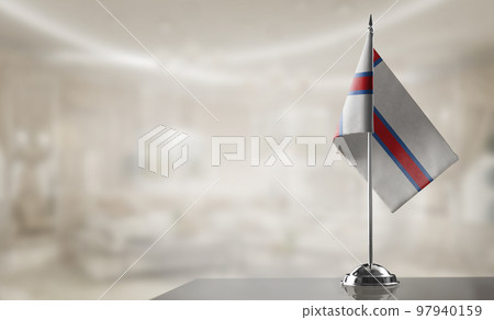 A small Faroe Islands flag on an abstract blurry background A small Faroe Islands flag on an abstract blurry background 97940159