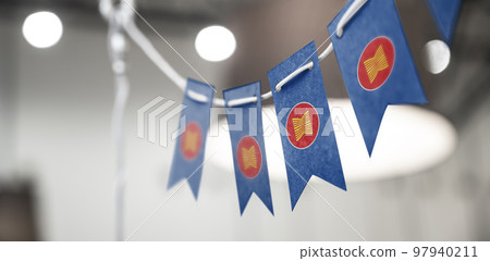 A garland of ASEAN national flags on an abstract blurred background 97940211