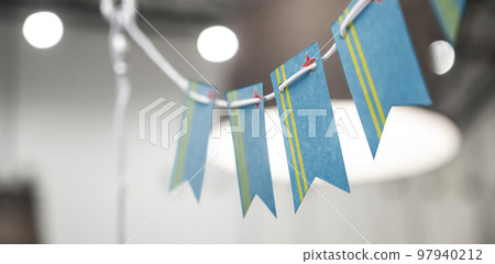 A garland of Aruba national flags on an abstract blurred background 97940212