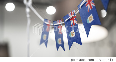 A garland of Anguilla national flags on an abstract blurred background 97940213