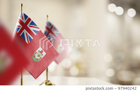 Small flags of the Bermuda on an abstract blurry background 97940242
