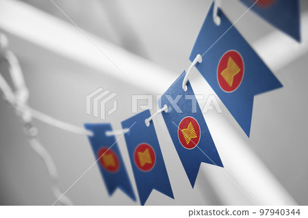 A garland of ASEAN national flags on an abstract blurred background 97940344