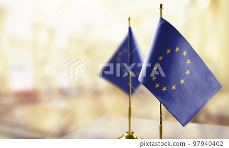 Small national flag of the European Union on a black background 97940402
