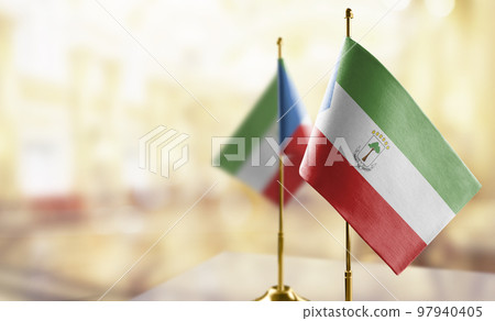 Small flags of the Equatorial Guinea on an abstract blurry background Small flags of the Equatorial Guinea on an abstract blurry background 97940405