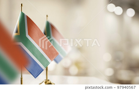 Small flags of the South Africa on an abstract blurry background Small flags of the South Africa on an abstract blurry background 97940567