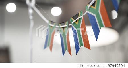A garland of South Africa national flags on an abstract blurred background A garland of South Africa national flags on an abstract blurred background 97940594