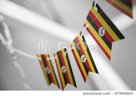 A garland of Uganda national flags on an abstract blurred background A garland of Uganda national flags on an abstract blurred background 97940664