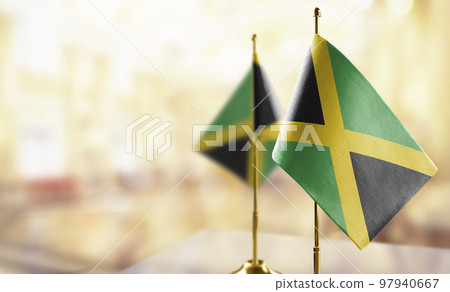 Small flags of the Jamaica on an abstract blurry background Small flags of the Jamaica on an abstract blurry background 97940667