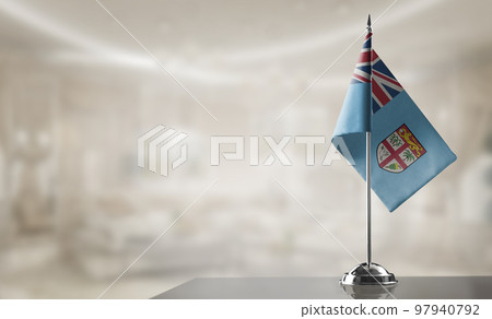 A small Fiji flag on an abstract blurry background 97940792