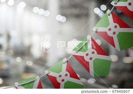 A garland of Burundi national flags on an abstract blurred background 97940807