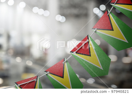 A garland of Guyana national flags on an abstract blurred background 97940821