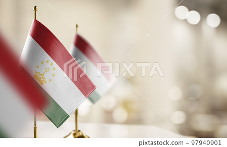 Small flags of the Tajikistan on an abstract blurry background Small flags of the Tajikistan on an abstract blurry background 97940901
