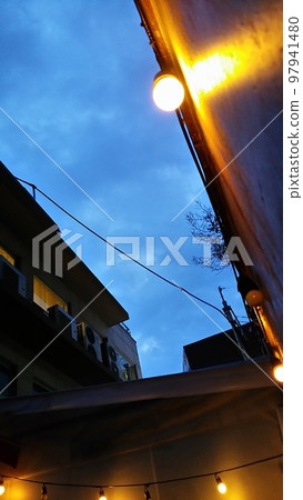 Dark blue sky seen between buildings at sunset 97941480