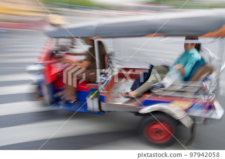 Traditional tuk-tuk from Bangkok, Thailand, in motion blur Traditional tuk-tuk from Bangkok, Thailand, in motion blur 97942058