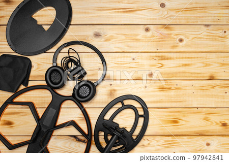 Accessories for metal detector on wooden background Accessories for metal detector on wooden background 97942841