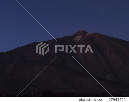 Long exposure night shot of the volcano Pico del Teide at Teide national park with stars on the blue sky. Tenerife Canary islands, Spain 97943721