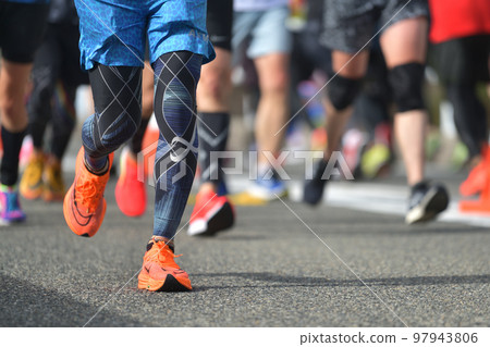 City marathon: the feet of a marathon runner running up a slope City marathon: the feet of a marathon runner running up a slope 97943806