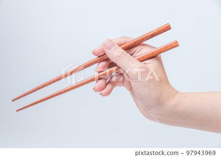 woman's hand with chopsticks 97943969