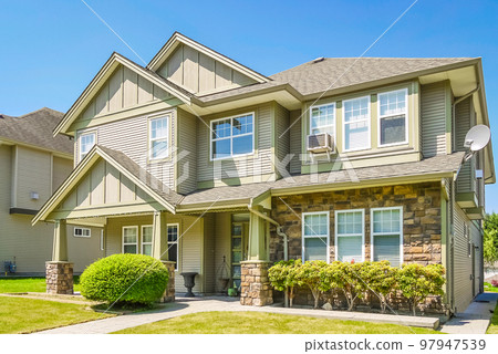 Luxury residential house with concrete pathway over front yard. 97947539